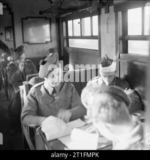 British Medical Services in the Second World War Medical Transport: Lightly wounded soldiers playing cards in a hospital train in Belgium. Trains were manned by both military and civilian crews, whose job it was to ensure safe and speedy travel to the casualties, including enemy wounded. Although disorganised and damaged by war, trains played an important part in transporting casualties from hospitals and dressing stations to bases and evacuation areas. Casualties who were able to walk were given comfortable saloon coaches for the journey. Stock Photo