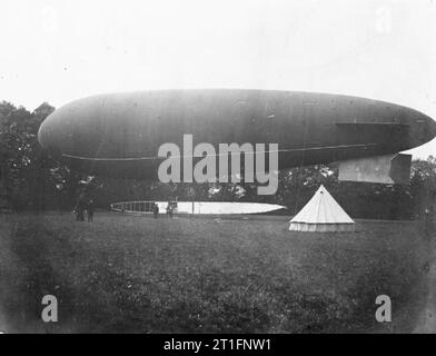 Aviation in Britain Before the First World War The army airship Gamma on the ground. Again the tail arrangement is different on the gondola, there is also no upper tail fin on the envelope. An army bell tent has been set up in front of the airship. Stock Photo