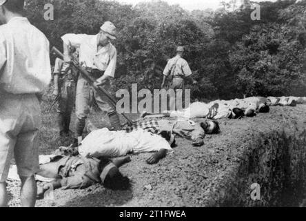 ATROCITIES CARRIED OUT BY JAPANESE FORCES DURING THE SECOND WORLD WAR WAR OFFICE, CENTRAL OFFICE OF INFORMATION AND AMERICAN SECOND WORLD WAR OFFICIAL COLLECTION. This set of four atrocity pictures was found among Japanese records when British troops entered Singapore. Picture shows:- The final act of brutality. One Japanese soldier can be seen bayonetting one of the victims. Stock Photo