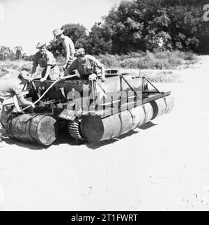 The British Army in Burma 1945 A Bren gun carrier fitted with empty oil drums as a flotation device after crossing the Mu River on the way to Mandalay, February 1945. Stock Photo