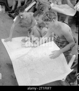 The British Reoccupation of Hong Kong, 1945 Three men of the 3rd Commando Brigade study a map of Hong Kong during their voyage to the colony on Landing Ship Tank LST 304. This vessel sailed as part of the first convoy to Hong Kong following the Japanese surrender. Stock Photo