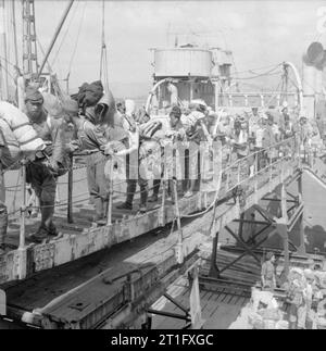 The British Reoccupation of Hong Kong Some of the first batch of Japanese naval prisoners of war board the SS FORT BUFFALO, which will carry them home to Japan. The ship would then return with supplies for other prisoners of war still held in Hong Kong. Embarkation of the prisoners was supervised by men of 42 and 44 Royal Marine Commados. Stock Photo
