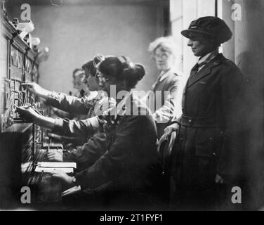 Olive Edis; Iwm Photographer of the Women's Services in France 1919 Queen Mary's Army Auxiliary Corps operators accompanied by Miss Low, Deputy Controller in a telephone exchange at Le Havre, France, circa 1919. Stock Photo