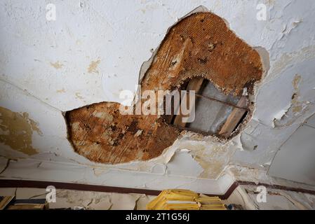 Water damaged ceiling in an old abandoned building Stock Photo