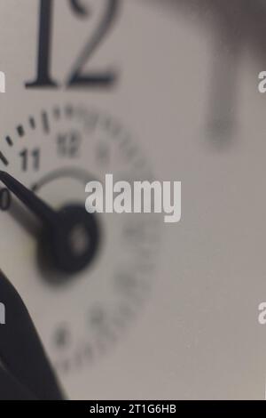 A very close up of an alarm clock's face with dial hand Stock Photo