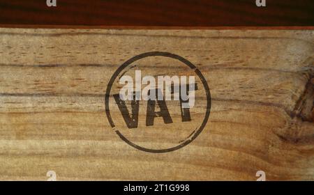 VAT stamp printed on wooden box. Value-added tax and invoice payment concept. Stock Photo