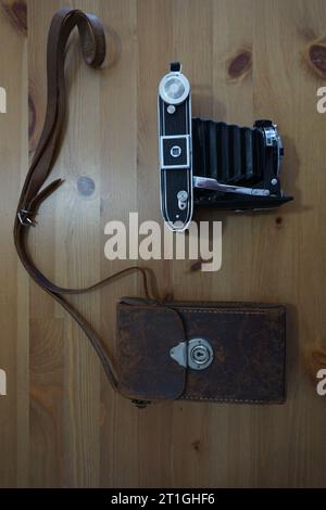 Antique camera with bellows. Leather bag and camera. Antique bellows camera and leather case. Stock Photo
