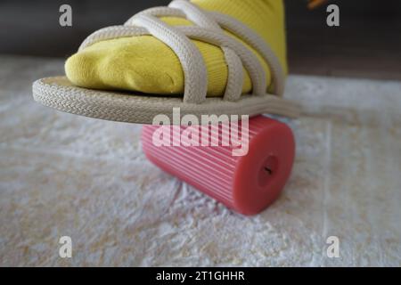 Objects printed with slippers. Stepping on a cable with slippers. Stepping on a candle with slippers. Stepping on objects with slippers inside the hou Stock Photo