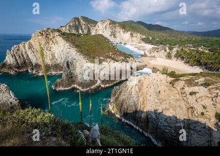 Cliffs and chasms harbor the beach in Maruata, Michoacan, Mexico. Stock Photo