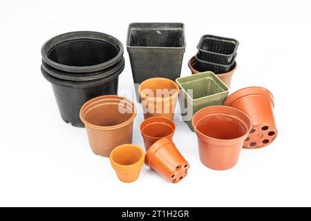 Different sizes and shapes of plastic pots for plants isolated on white background Stock Photo