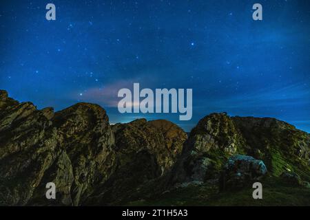 Silhouette of a young man at night on Mount Aiako Harria in Oiartzun. Basque Country Stock Photo