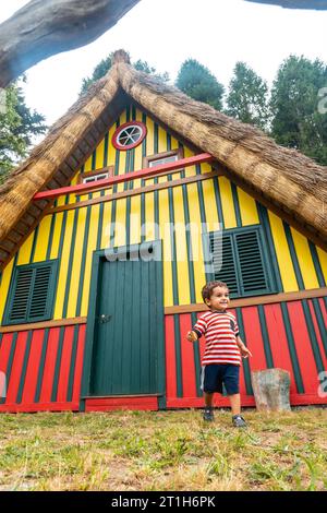 Playing in a traditional Madeiran house like those of Santana in the forest of Caldeirao Verde, Santana Stock Photo