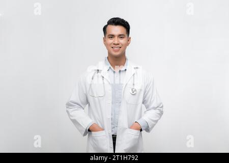 Young handsome man wearing doctor uniform and stethoscope with a happy and cool smile on face. Stock Photo