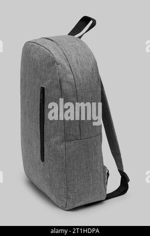 close up trendy fashionable school backpack grey color isolated on white background with clipping path. side view shoulder strap bag. Stock Photo