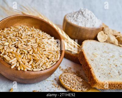 Beautiful still life arrangement of variety of wheat products; kamut, bulgur, flour, grain bread, and wheat cereal. Image contains gluten. Stock Photo