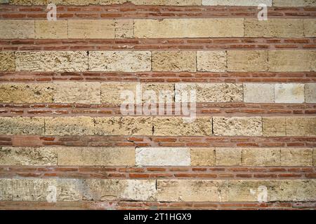 Sturdy yellow and beige cut stone brick wall, good for backgrounds, seamless lined up Stock Photo