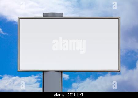 Close-up on a blank billboard against a cloudy sky. Stock Photo