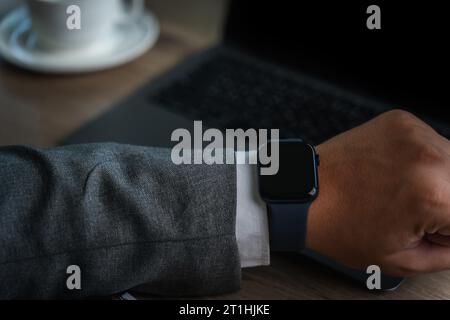 Man checking time on his smartwatch device Close-up display clock checking lifestyle communication phone mobile touch app technology Stock Photo