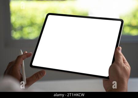 Digital tablet computer close up man using tablet hands man multitasking with isolated screen Stock Photo