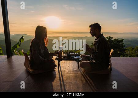 a couple on vacation in Thailand waking up with drip coffee in the morning, with a look at the mountains of Doi Chang Chiang Rai Thailand Stock Photo