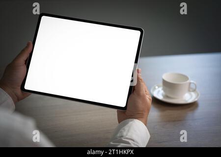 Digital tablet computer close up man using tablet hands man multitasking with isolated screen Stock Photo