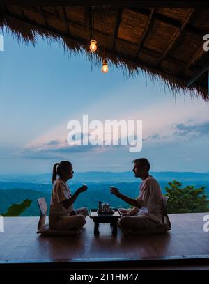 a couple on vacation in Thailand waking up with drip coffee in the morning with a look at the mountains of Doi Chang Chiang Rai Thailand Stock Photo