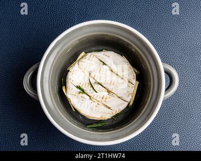 Camembert cheese in a saucepan for baking close-up view from above Stock Photo