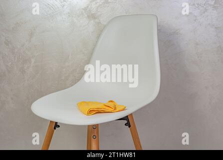 white chair and yellow cleaning cloth Stock Photo