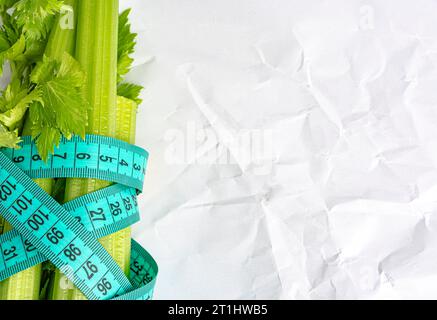 fresh celery and centimeter tape on white background Stock Photo