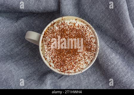 cup of coffee on gray fabric background Stock Photo