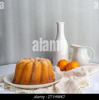 cupcake on a white napkin, two tangerines Stock Photo