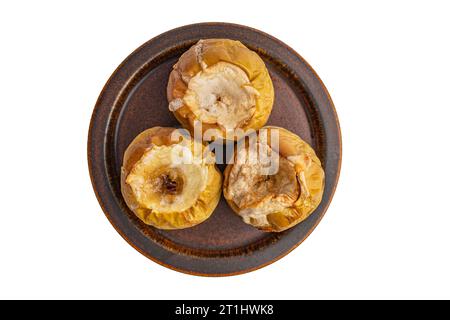 baked apples on a ceramic brown plate Stock Photo