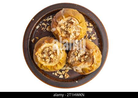 baked apples with nuts on a ceramic brown plate Stock Photo