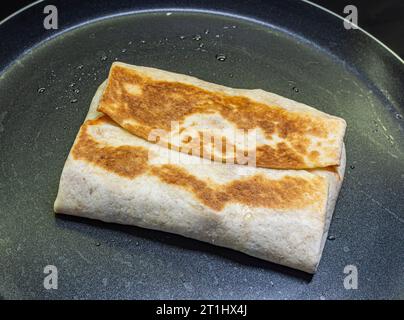 fried pita on a black frying pan Stock Photo