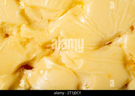 Gruyere cheese on a copper plate. Slices of gruyere cheese on wooden background. Close up Stock Photo
