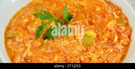 One of the most eaten dishes of Turkish cuisine is menemen, isolated on white background Stock Photo