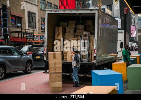 New York,  New York state  USA - August, 30, 2023 - Delivery Man Near Truck Car. Courier Delivering Package Stock Photo