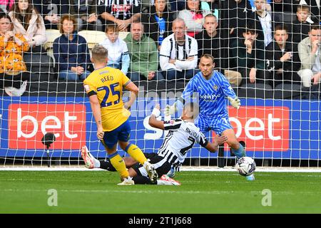 Louis Reed of Mansfield Town scores the opener to make it 1-0 during ...