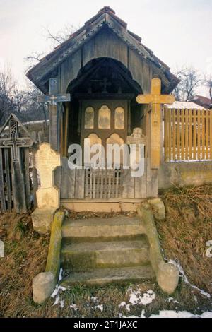 Tutana, Arges County, Romania, 2000. Roadside crucifix from 1932, for protection and blessing. Other crosses are added according to the local tradition: for every dead in the village a cross is placed in the cemetery and another one on a wayside. Stock Photo