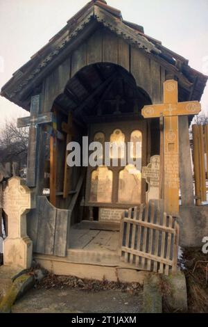 Tutana, Arges County, Romania, 2000. Roadside crucifix from 1932, for protection and blessing. Other crosses are added according to the local tradition: for every dead in the village a cross is placed in the cemetery and another one on a wayside. Stock Photo