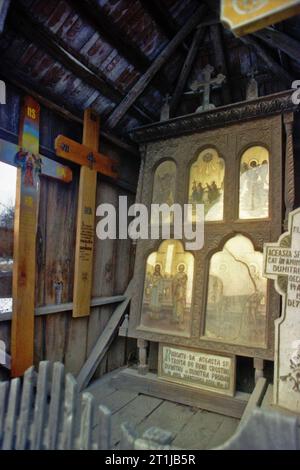 Tutana, Arges County, Romania, 2000. Roadside crucifix from 1932, for protection and blessing. Other crosses are added according to the local tradition: for every dead in the village a cross is placed in the cemetery and another one on a wayside. Stock Photo