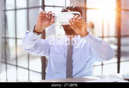 young businessman wearing virtual reality glasses in the office Stock Photo