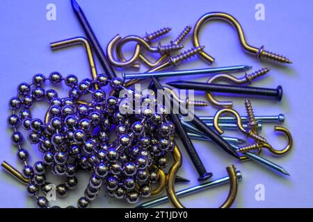 A colorful mix of nails and screws with eyelets and hoes Stock Photo