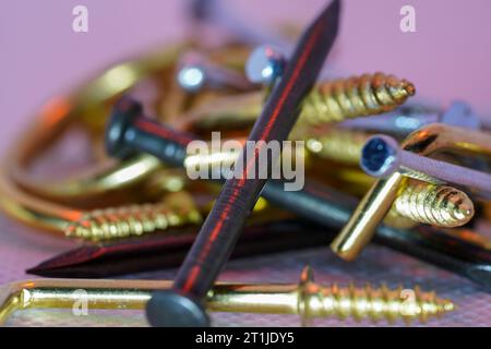 A colorful mix of nails and screws with eyelets and hoes Stock Photo