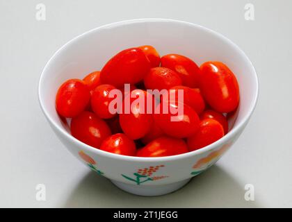 Bowl of baby plum tomatoes. Stock Photo