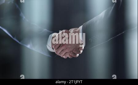 Close-up image of handshake between two colleagues. Stock Photo