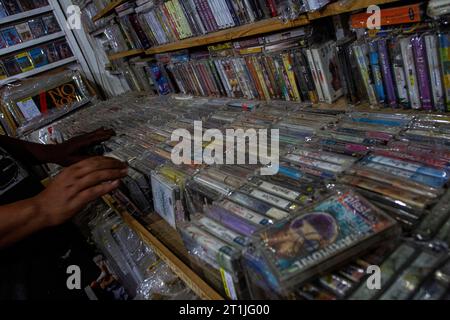 Bantul, Yogyakarta, Indonesia. 14th Oct, 2023. A shop owner prepares physical album recordings in cassette format at a music shop called Toko Musik Luwes in Bantul. According to data released by the Recording Industry Association of America (RIAA), music revenues are increasing, driven primarily by streaming services but also by sales of physical music formats. The report found that revenues from physical music formats have gradually increased over the years. Overall physical music revenue rose 4 percent last year, driven by a 17 percent increase in vinyl records. Physical releases of music Stock Photo