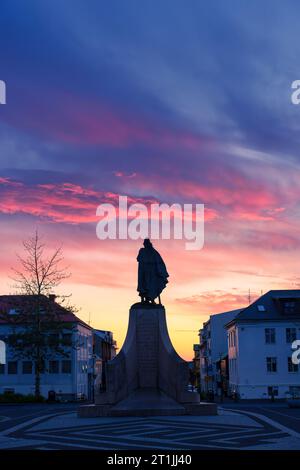 Silhouette of prominent monument statue of Leif Erikson, a famous Icelandic explorer in front of main entrain the Hallgrímskirkja church in the sunset Stock Photo