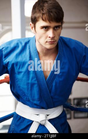 Man, karate and fight, sports contest with muay thai and training for self defense in gym. Athlete, combat and power with fitness, martial arts and Stock Photo