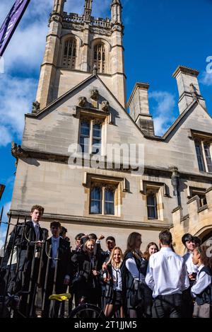 Oxford, UK, 14th October 2023. Oxford University Freshers in white tie and gowns queue to punt on the River Cherwell at Magdalen Bridge boathouse after their Matriculation ceremony. Credit: Martin Anderson/Alamy Live News Stock Photo